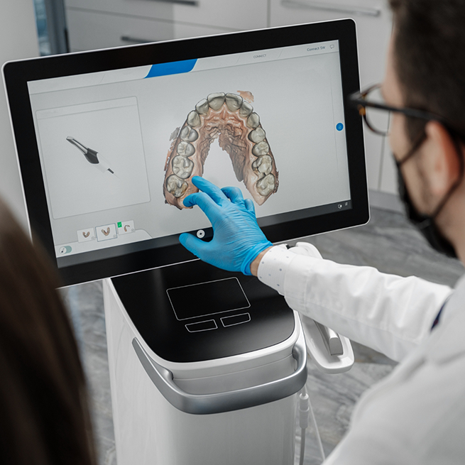 Dentist looking at digital impression on monitor