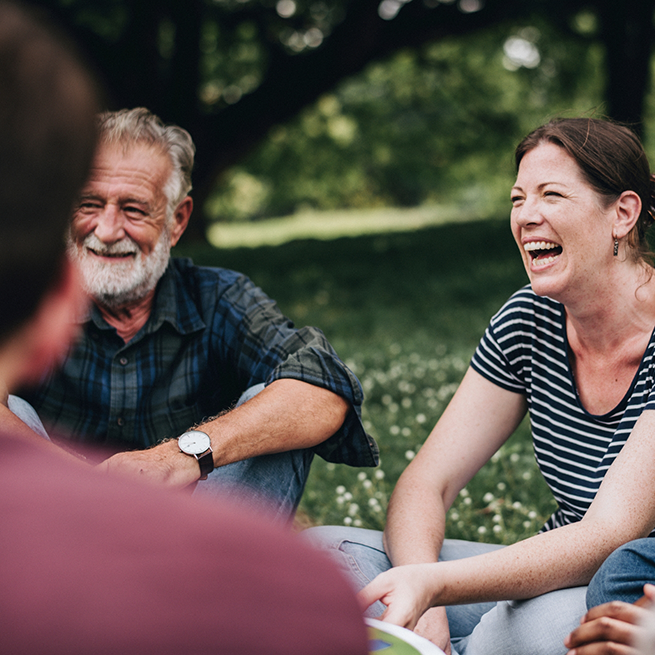 Man and woman sitting outside and talking with friends