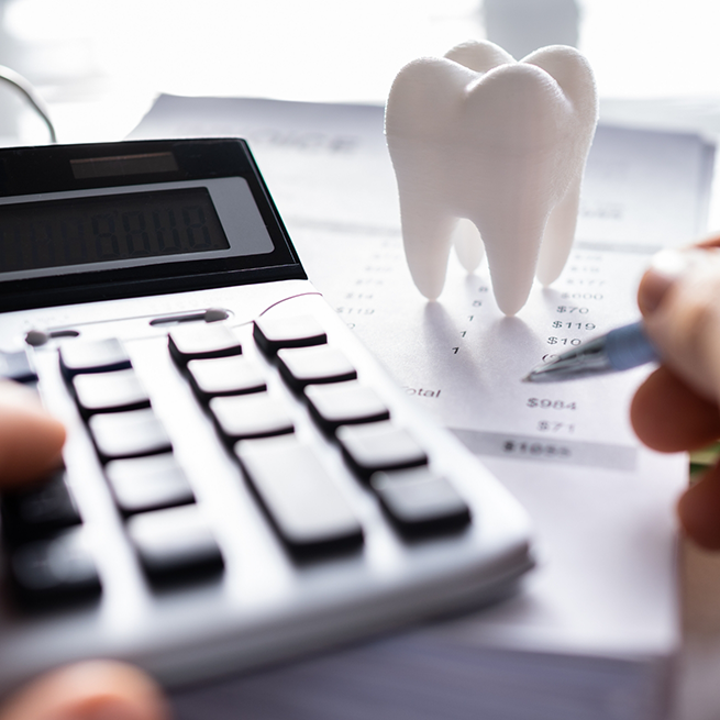 Calculator, papers, and tooth-shaped paperweight