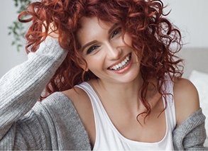 Close-up of woman with red hair smiling