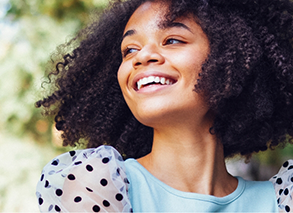 Woman outside on sunny day smiling